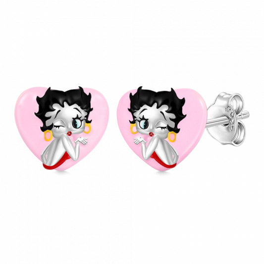Laissez-vous séduire par ces boucles d’oreilles en argent 925 mettant en scène Betty Boop aux côtés d’un délicat cœur rose. Un duo glamour et tendre qui apporte une touche rétro et féminine à votre style. Parfaites pour les fans de l’icône intemporelle et les amoureuses des bijoux originaux.