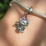 Apportez une touche d’élégance et de charme à votre collection avec ce charm pendentif représentant Marie, la ravissante chatte blanche des Aristochats. Finement travaillé en finition argentée brillante, ce bijou met en valeur son célèbre nœud rose délicatement posé sur la tête, symbole de sa douceur et de sa grâce. Une pièce parfaite pour les amateurs de Disney et les passionnés de félins sophistiqués.