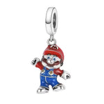 Charm pendentif inspiré de Super Mario. Ce bijou en argent 925 met en scène Mario dans sa tenue iconique (casquette rouge avec « M », moustache, boutons dorés), avec des détails en émail rouge, bleu et doré. Un charm ludique et reconnaissable, parfait pour les fans de Nintendo et les amateurs de bijoux gaming.

Caractéristiques :

- Matière : Argent 925 avec émail rouge, bleu et doré.
- Design : Mario en tenue iconique (casquette « M », moustache, boutons dorés).
- Style : Bijou gaming, fun, collector et mo