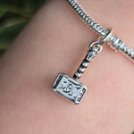 Apportez une touche divine et héroïque à votre collection avec ce charm représentant Mjolnir, le marteau légendaire de Thor. Fabriqué en argent sterling 925, ce charm de haute qualité est compatible avec tous les bracelets Pandora, garantissant une intégration parfaite à votre bijou préféré. Idéal pour les fans de Thor et de l'univers Marvel, ce charm capture la puissance et l'autorité du dieu du tonnerre, ajoutant une note de force et de mythologie nordique à votre bracelet.