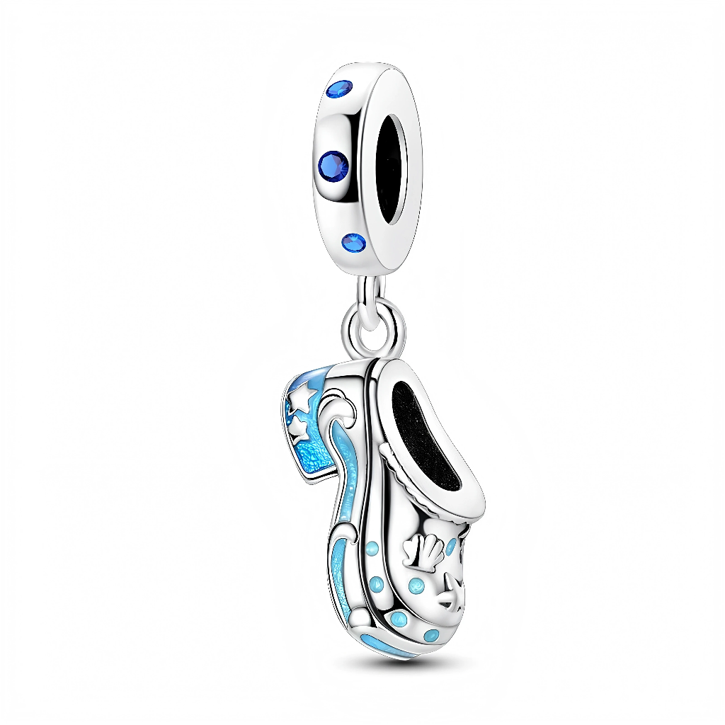 Ce charm pendant en argent 925 représente une petite mule ouverte, décorée de coquillages et d’étoiles de mer en relief le long de la tige. Des vagues et pois émaillés dans un dégradé de bleu lagon animent la chaussure, tandis que la bélière lisse est rehaussée de petites pierres rondes bleues qui ajoutent un éclat marin.

Caractéristiques :

-Matière : Argent 925 avec émail bleu et pierres synthétiques bleues.
-Design : Mule de plage stylisée ornée de coquillages et étoiles de mer, bélière sertie de petite