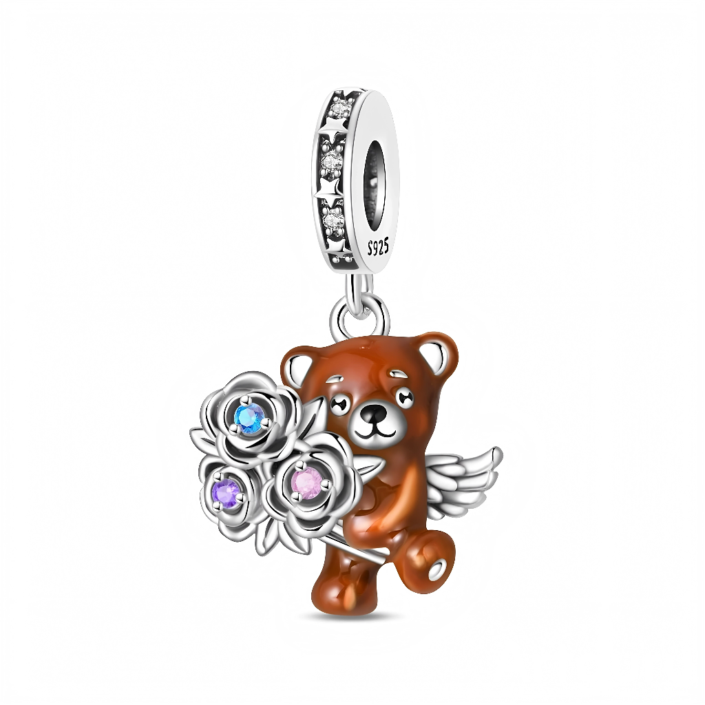 Suspendu à une bélière sertie de petites étoiles scintillantes, l’ourson brun est détaillé avec un regard doux et de délicates ailes d’ange en argent qui renforcent son côté protecteur. Entre ses pattes, il tient trois roses argentées dont les cœurs sont ornés de cristaux colorés, apportant des reflets bleus, violets et roses pour un effet féerique. Ce charm plein de poésie est idéal comme cadeau pour dire « je pense à toi », célébrer une naissance, la Saint‑Valentin ou tout moment où l’on veut offrir un pe