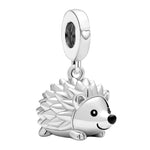 Charm pendentif représentant un adorable hérisson argenté, avec ses piquants finement détaillés, son petit cœur gravé sur l’anneau et son expression souriante. Son design délicat et attendrissant en fait un bijou original, parfait pour les amoureux des animaux.

Caractéristiques :

Matière : Argent 925 avec détails brillants.
Design : Hérisson souriant avec piquants détaillés et petit cœur décoratif.
Style : Mignon, élégant, original et raffiné.
Symbolique : Douceur, protection, curiosité, affection et pers
